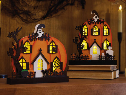 An assortment of Halloween home decor featuring glowing pumpkins.