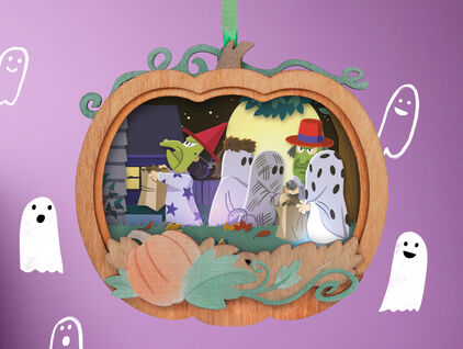 A Halloween ornament featuring the Peanuts gang trick or treating.